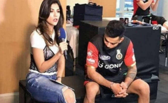 महिला एंकर की फटी जींस को ताकते कैमरे में कैद हुए विराट कोहली, तसवीर वायरल