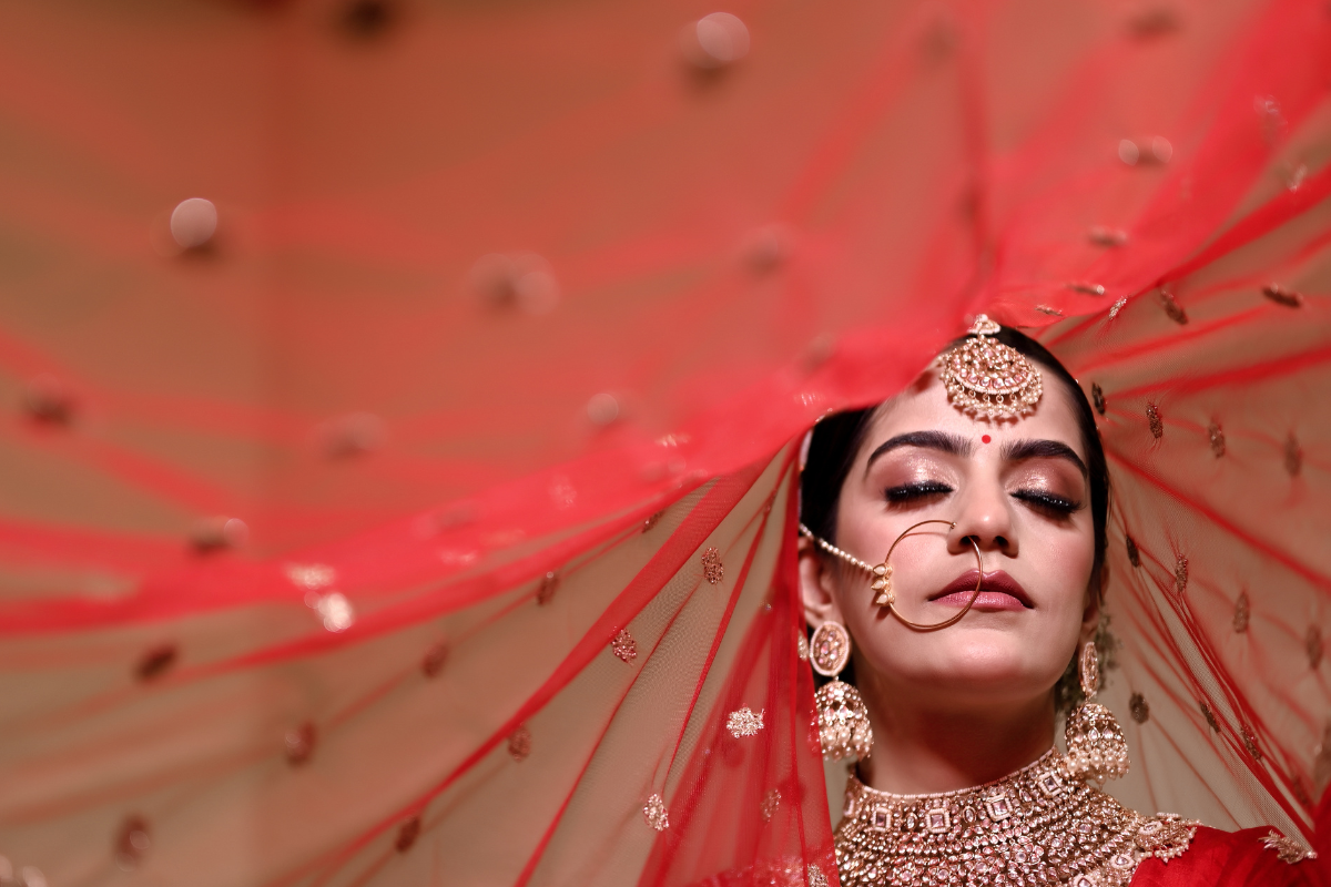 Elegant woman with Ghoonghat pose in saree for Teej photoshoot idea.