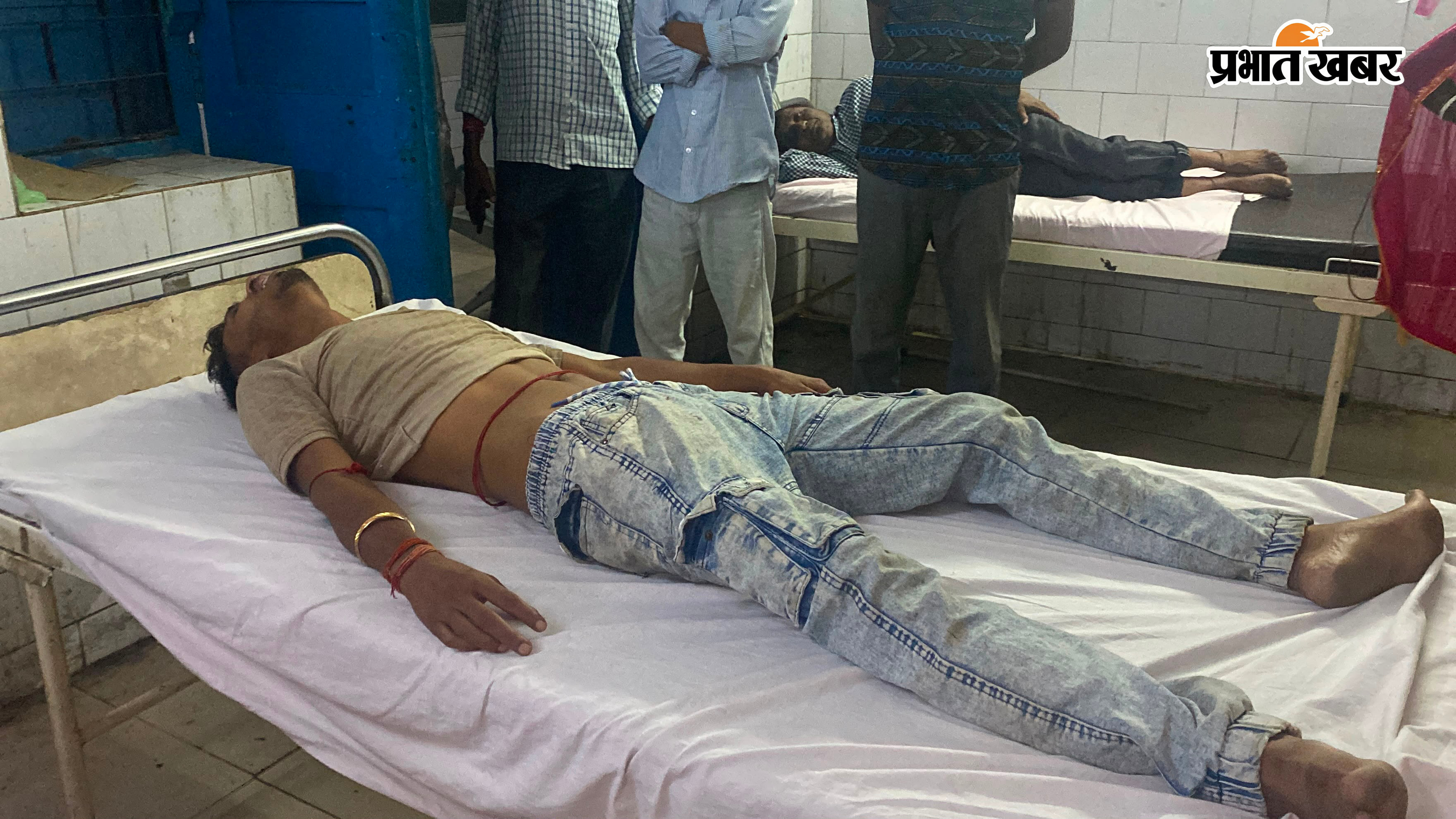 घायल युवक का इलाज करते स्वास्थ्यकर्मी व अचेत अवस्था में पड़ा युवक | Prabhat Khabar Network
